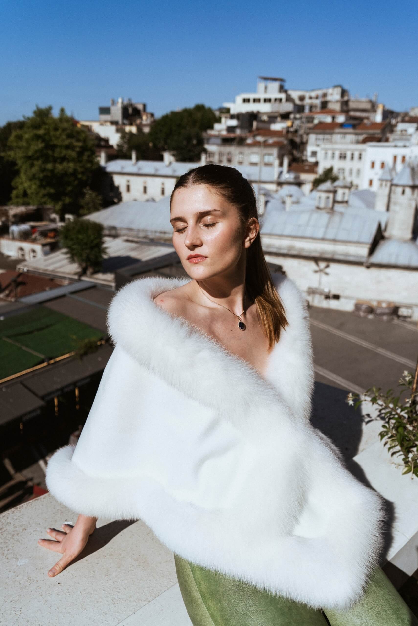 a woman in a real white fox fur scarf