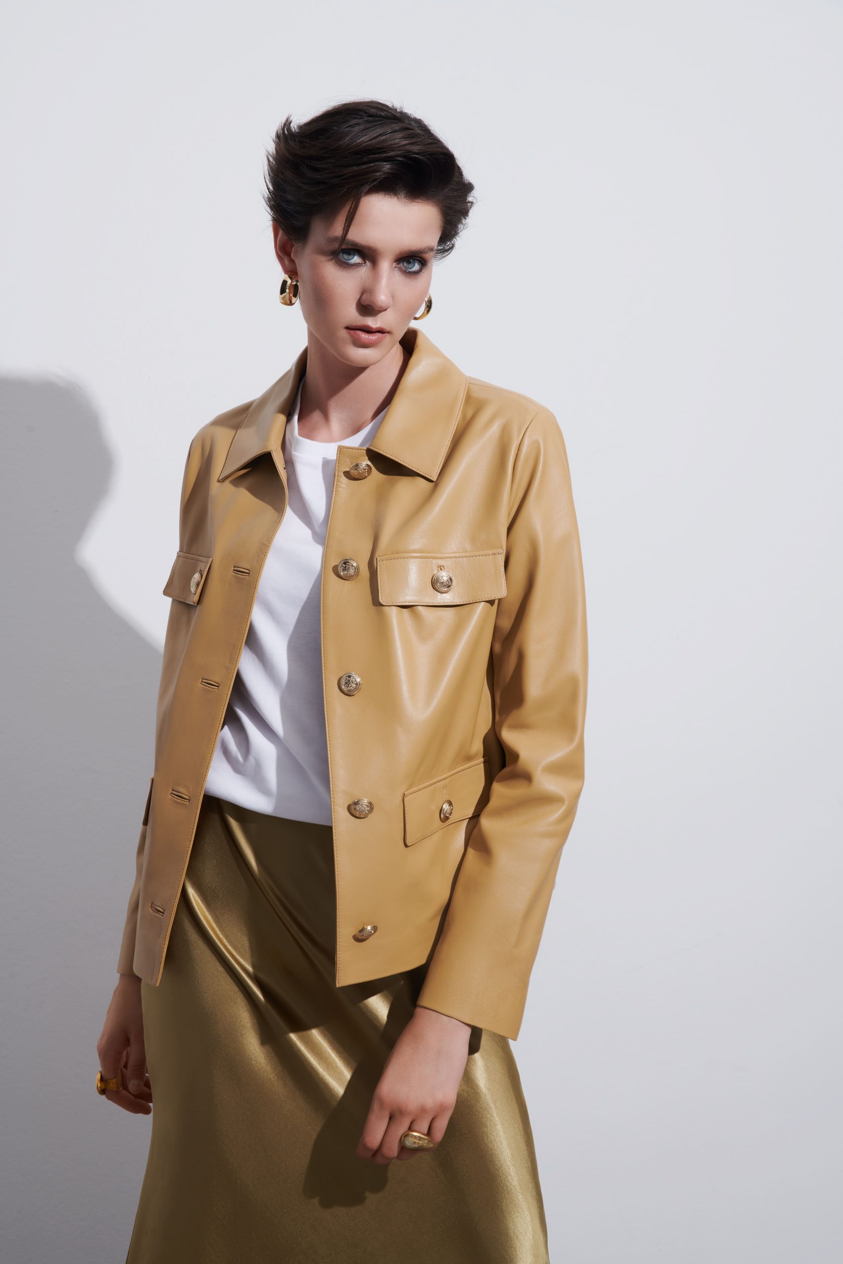 woman in a tobacco colord leather blazer jacket