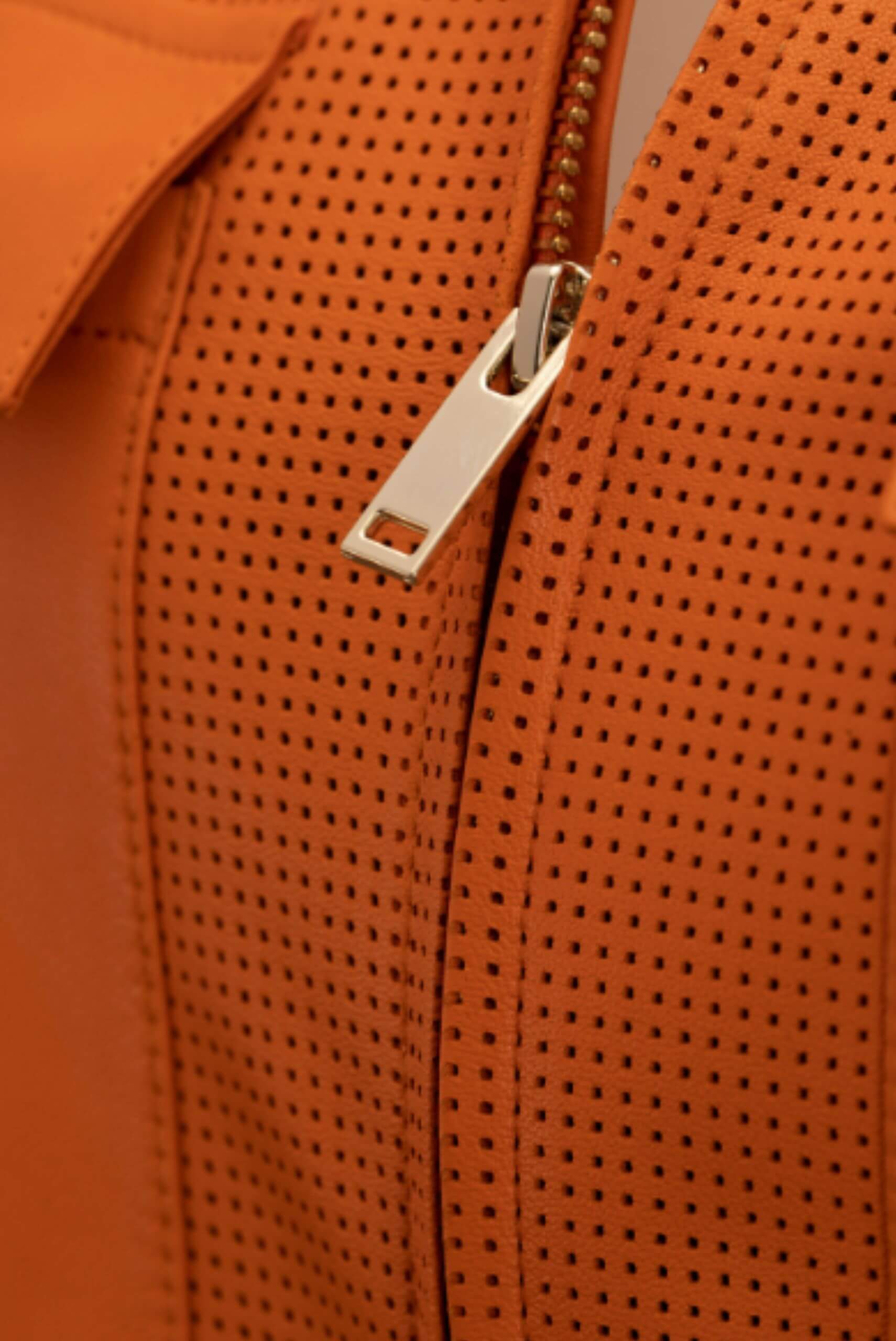 close up of orange perforated leather