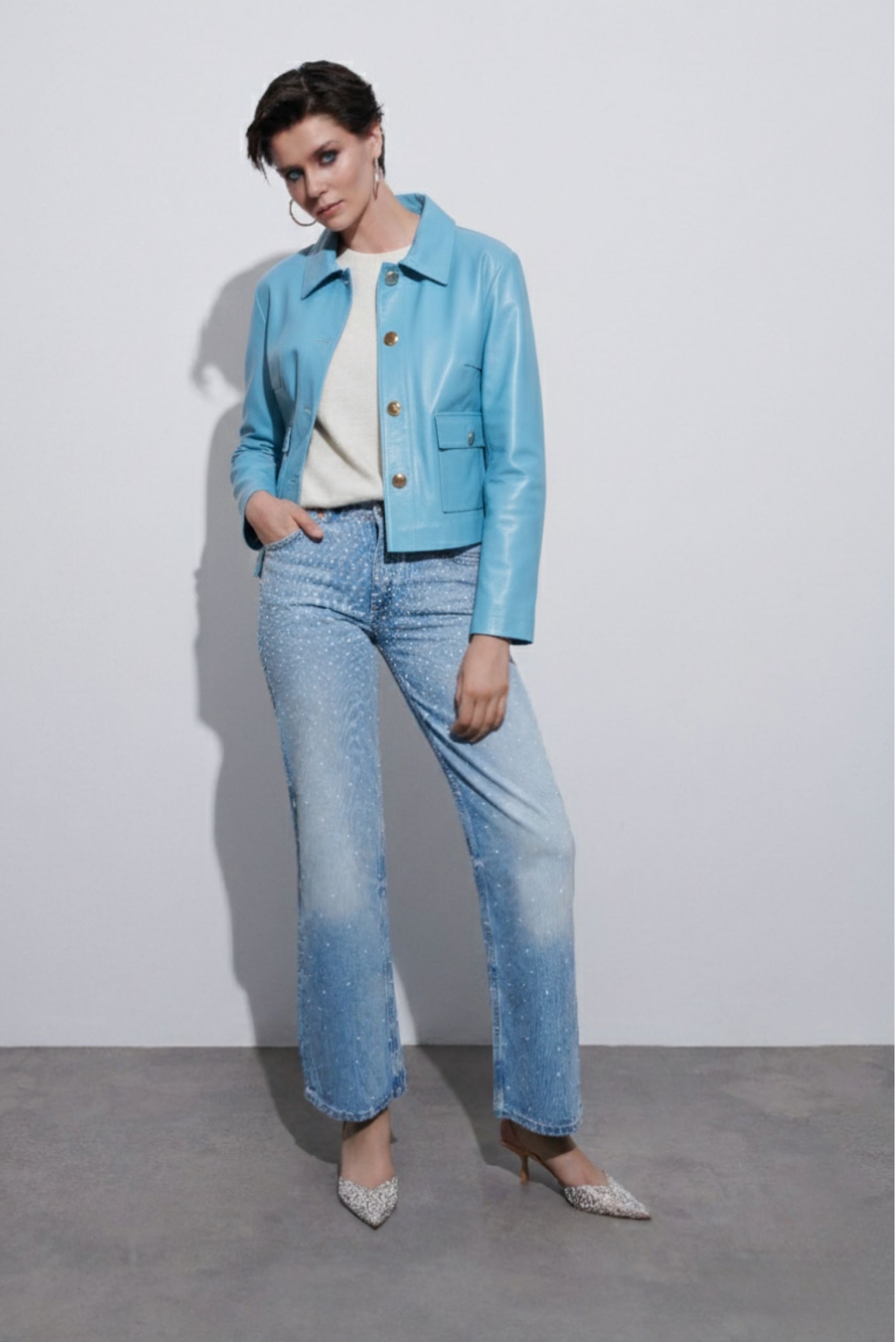 Blue leather jacket outfit for women, paired with jeans, stylish and timeless fashion