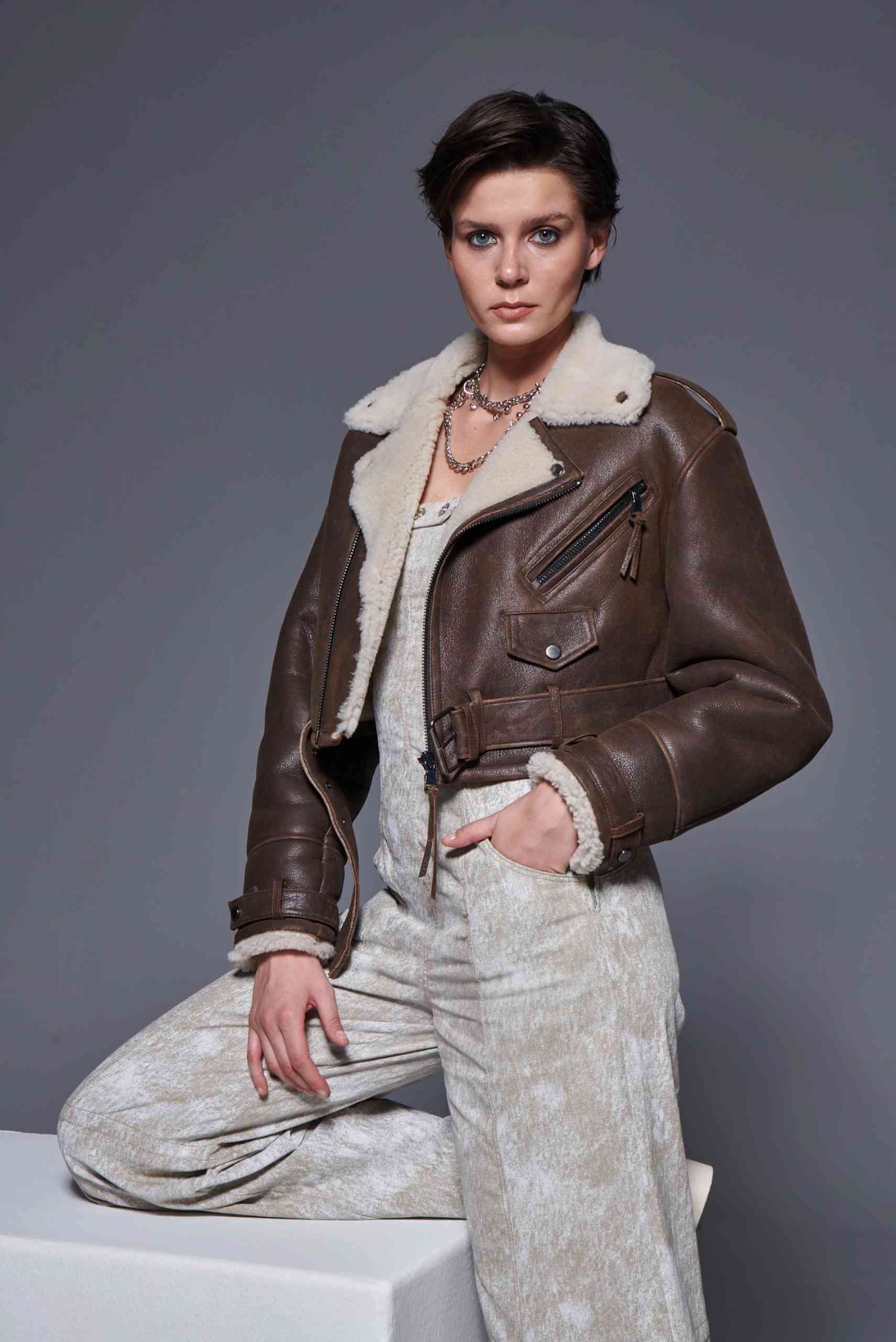 Woman wearing a real brown shearling leather jacket with wool lining — handcrafted winter outerwear symbolizing quiet luxury and Turkish craftsmanship.