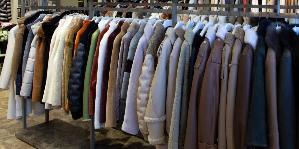 A collection of luxury shearling jackets in neutral tones displayed in an Istanbul boutique — showcasing craftsmanship, warmth, and timeless winter style.